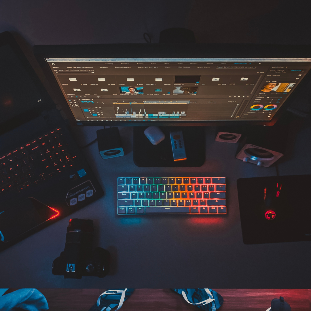 rainbow glowing keyboard and dimly lit computer desk